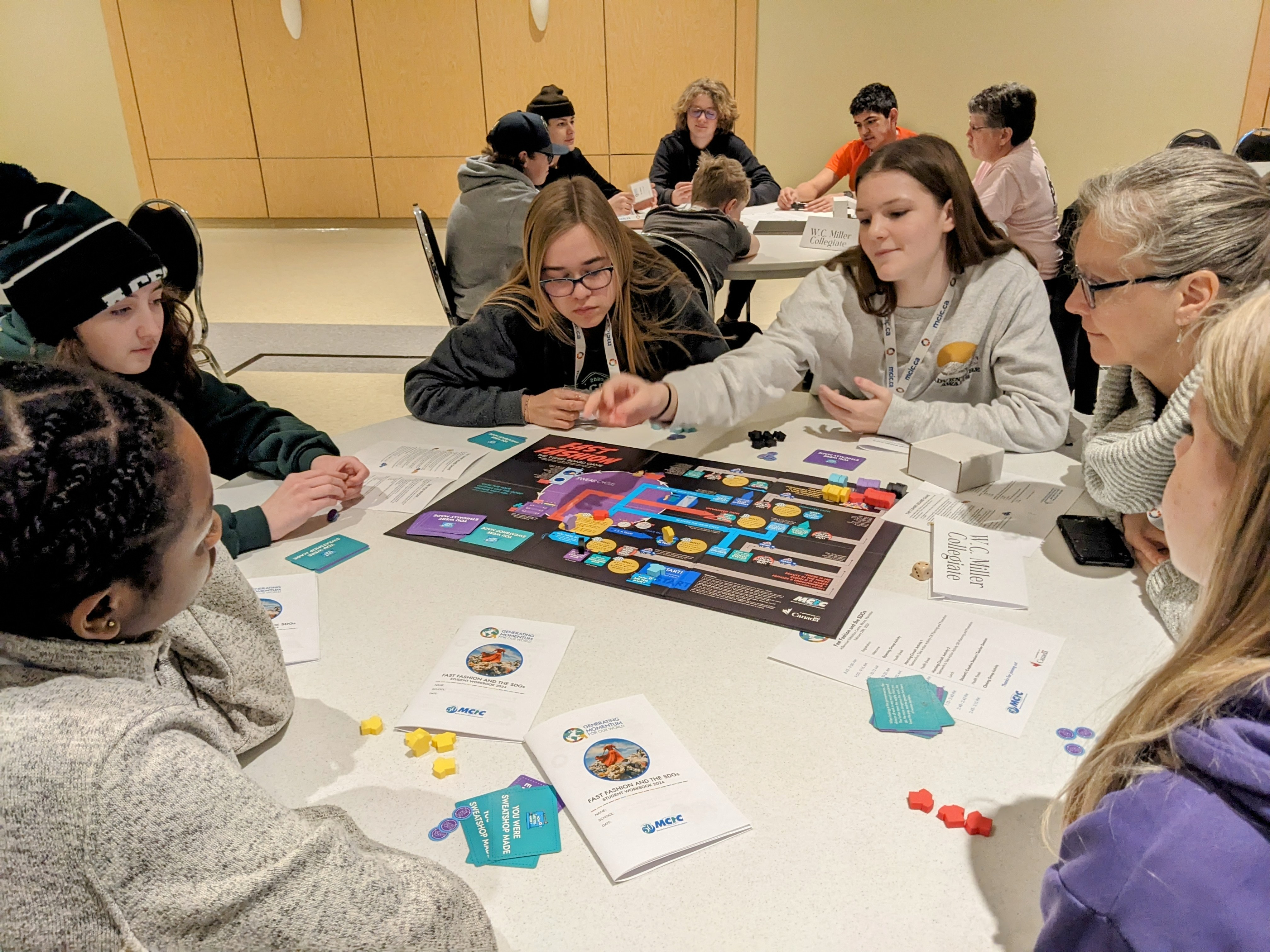 A group of students play the t-shirt board game